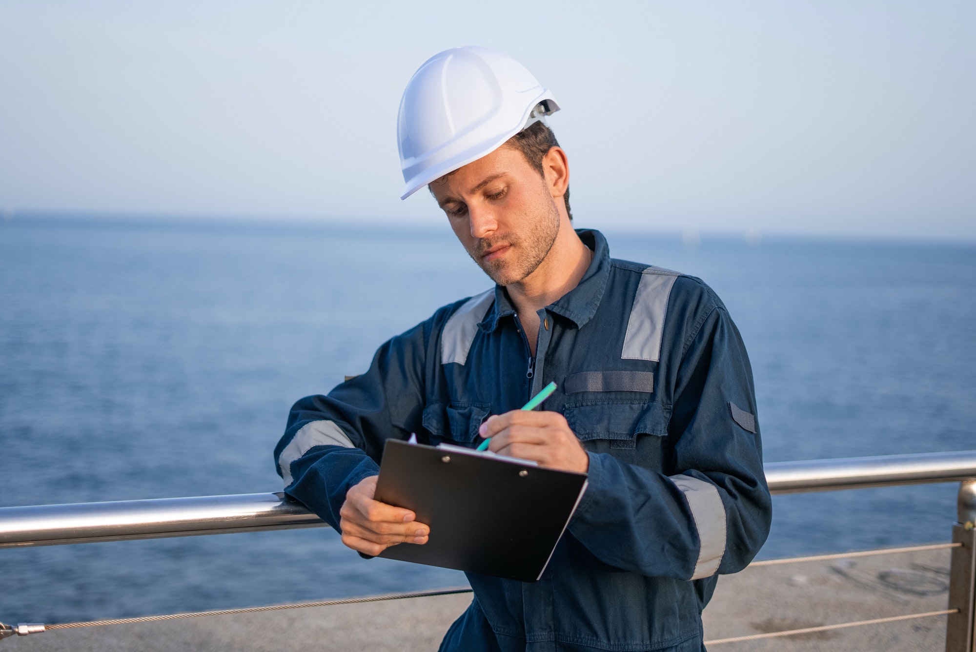 Engineer with clipboard working in port